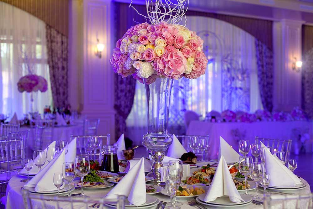 Table setting at a luxury wedding reception. Beautiful flowers on the table.